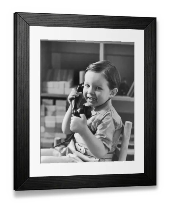 Framed Print : Boy (2-4) holding telephone (B&W) Framed Print : Boy (2-4) holding telephone (B&W)