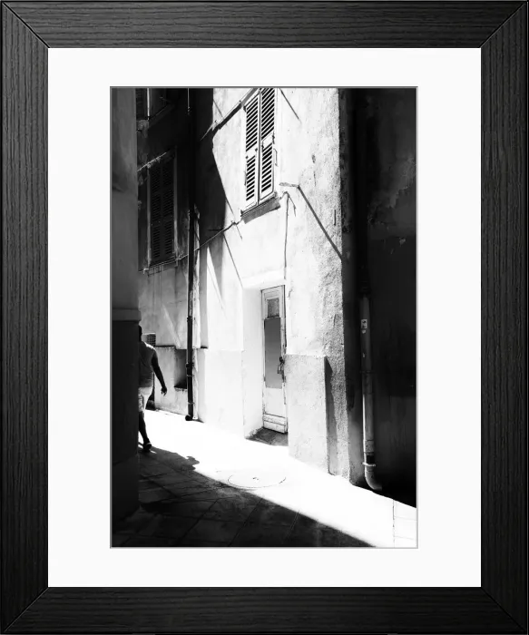 Framed Print : A man walking down a street in Old Nice, France Framed Print : A man walking down a street in Old Nice, France