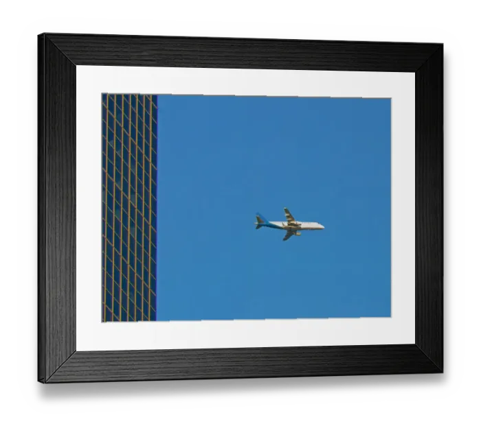 Framed Print : Flyby. A color photograph of a commercial passenger jet flying past a commercial Framed Print : Flyby. A color photograph of a commercial passenger jet flying past a commercial