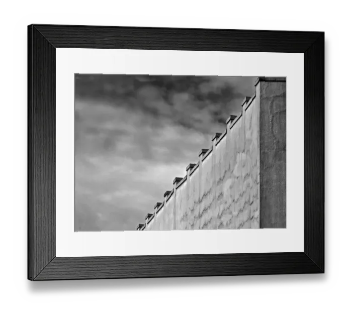 Framed Print : Gray Wall. A black and white photograph of the surrounding wall to a commercial