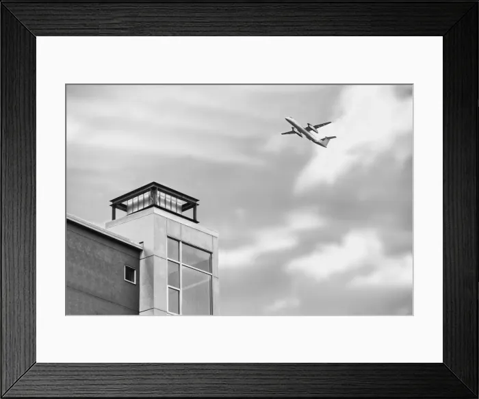 Framed Print : Flyover. A black and white photograph of a commercial aircraft flying over Framed Print : Flyover. A black and white photograph of a commercial aircraft flying over