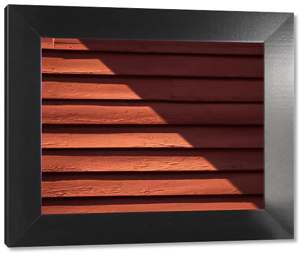 Red Shade. A color photograph of the wooden wall to a commercial building