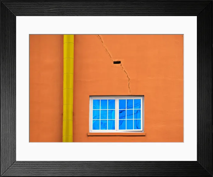 Framed Print : Neon Pipe. A color photograph of the wall to an aging commercial building