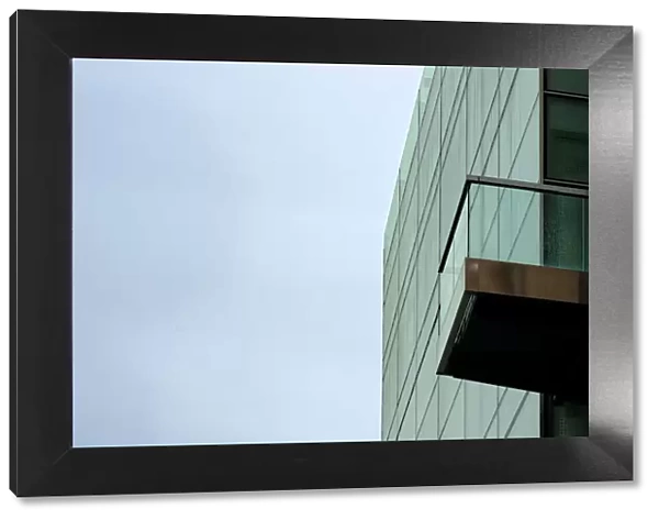 Glass Sky. A color photograph of a commercial building with a balcony in downtown Portland