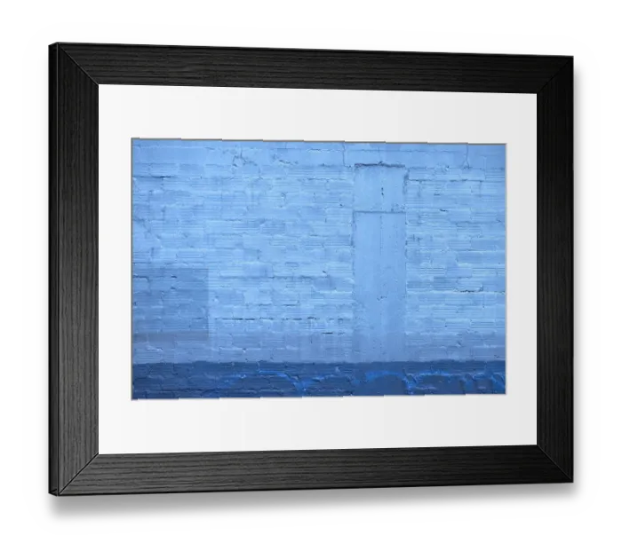 Framed Print : Blue Wall. A color photograph of the wall to an aging commercial building