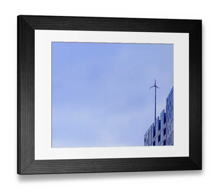 Framed Print : Sky Wheel. A color photo of a wind turbine on the roof of a skyscraper