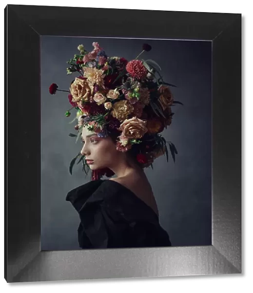 Thoughtful young woman in floral headdress