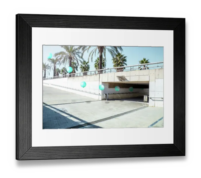 Framed Print : Poetic stop motion picture of green balloons following each other going out from tunnel in a minimal and cool underground pass in the city