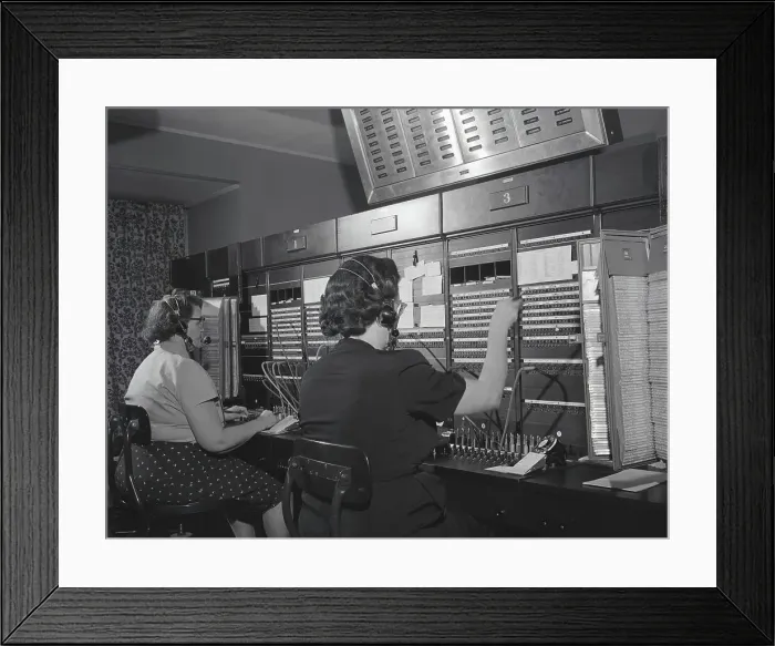 Framed Print : Two women wearing headsets, working on telephone switchboard. (Photo by H. Armstrong Roberts / Retrofile / Getty Images)