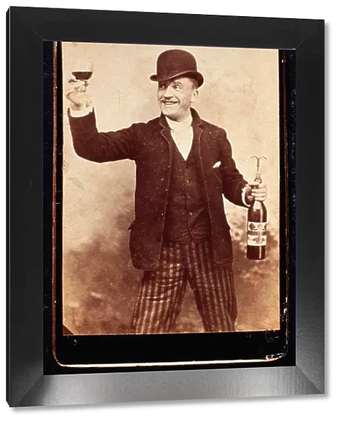 Smiling Man Holding a Wineglass and Wine Bottle