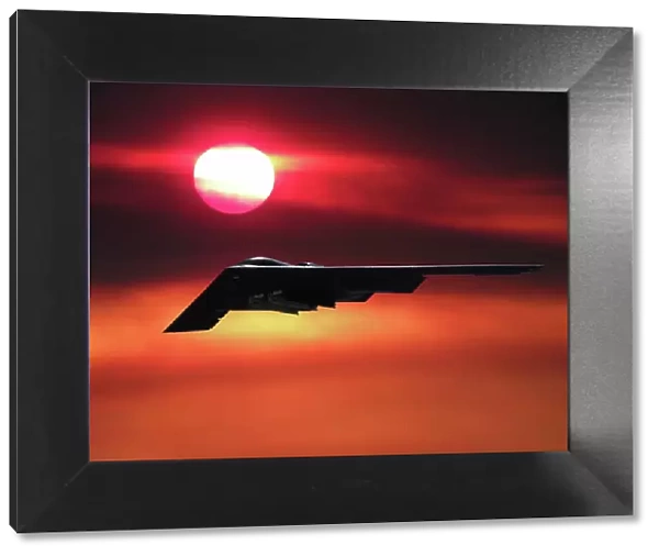 Inflight view of a USAF Northrop Grumman B-2A stealth bomber in a sunset