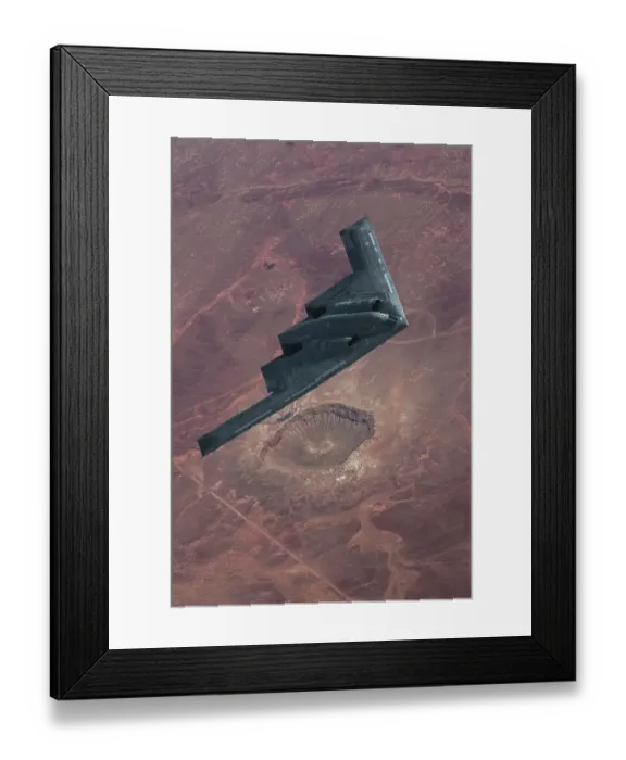 Framed Print : Inflight view of a USAF Northrop Grumman B-2A stealth bomber over the Barringer Meteor Crater in Arizona Framed Print : Inflight view of a USAF Northrop Grumman B-2A stealth bomber over the Barringer Meteor Crater in Arizona