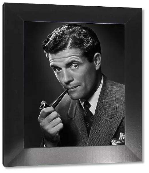 A smartly-dressed man smoking a pipe, circa 1950. (Photo by Retrofile / Hulton Archive / Getty Images)
