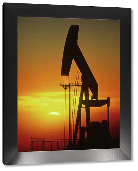Oil Rig. Oil drilling rig with setting sun