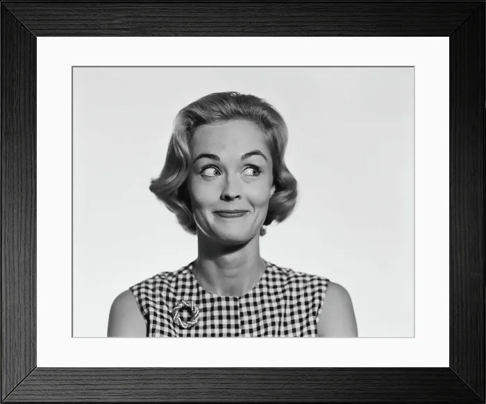 Framed Print : Young woman glancing sideways, smiling Framed Print : Young woman glancing sideways, smiling