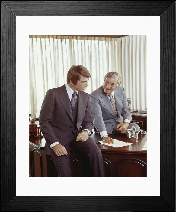 Framed Print : Two businessmen at desk looking at document