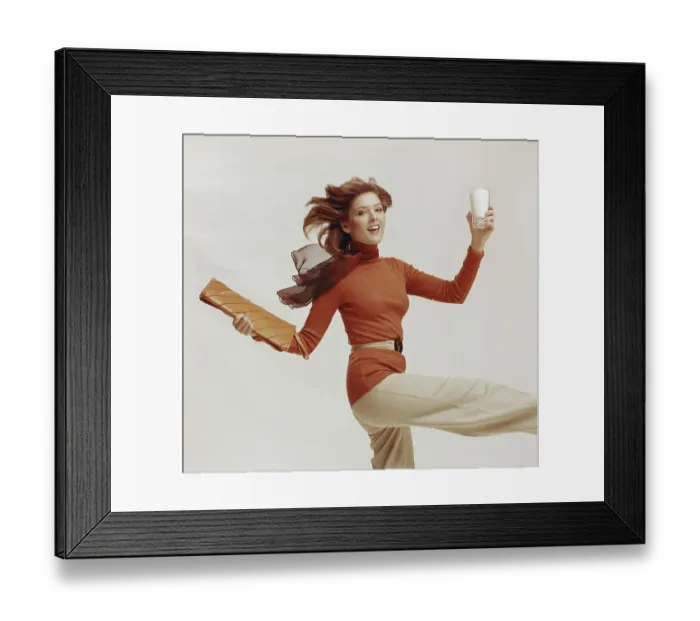Framed Print : Woman holding glass of milk and file, smiling, portrait
