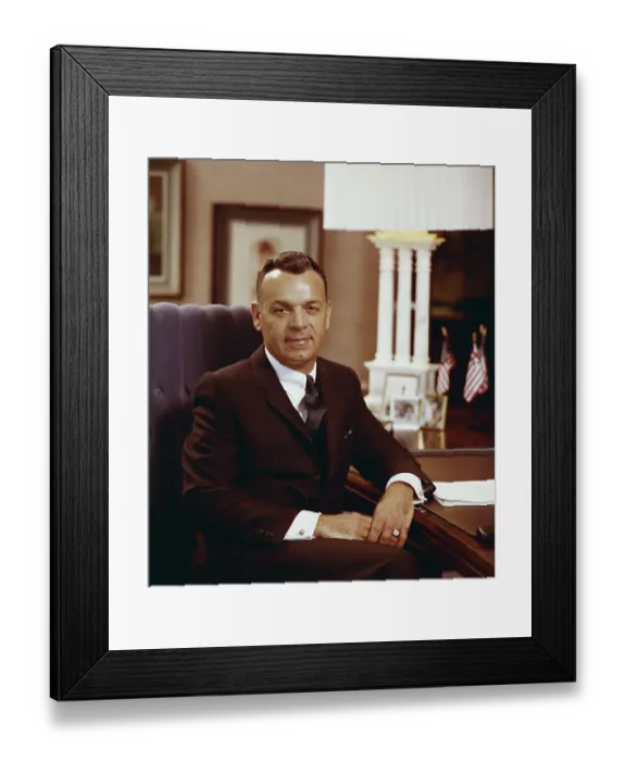 Framed Print : Businessman sitting in armchair, smiling, portrait Framed Print : Businessman sitting in armchair, smiling, portrait