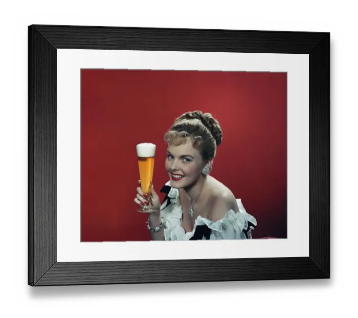 Framed Print : Young woman holding beer glass, smiling, portrait Framed Print : Young woman holding beer glass, smiling, portrait