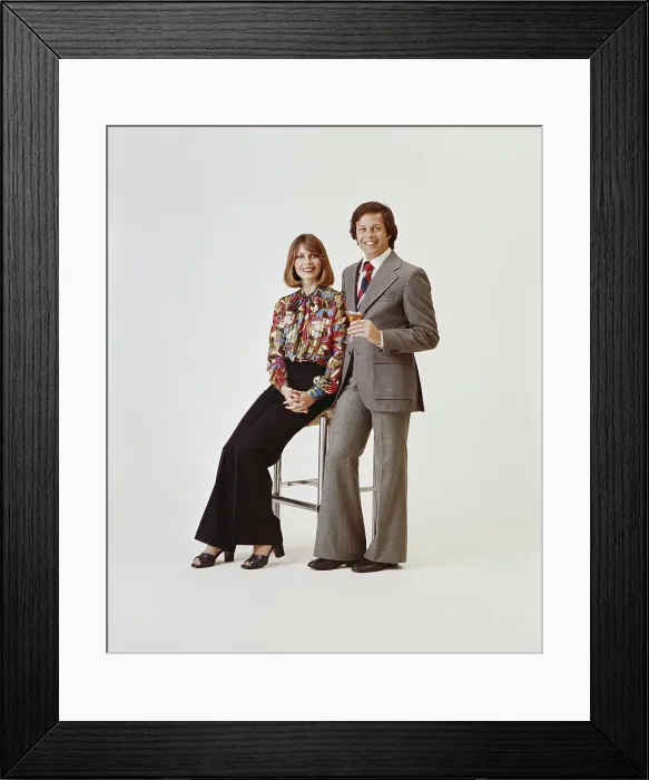 Framed Print : Couple on white background, man holding drink Framed Print : Couple on white background, man holding drink