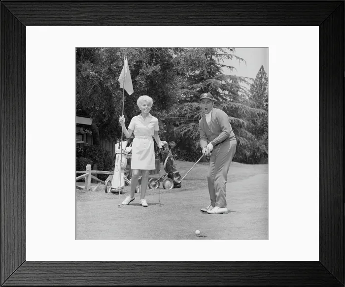Framed Print : Mature man putting ball into hole Framed Print : Mature man putting ball into hole