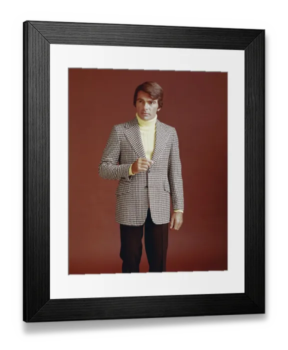 Framed Print : Man in suit standing against red background Framed Print : Man in suit standing against red background