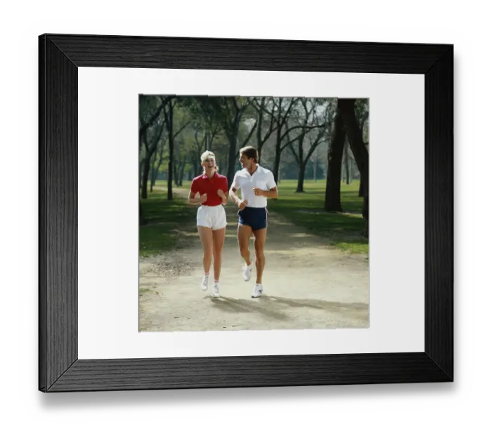Framed Print : Couple jogging in park, smiling