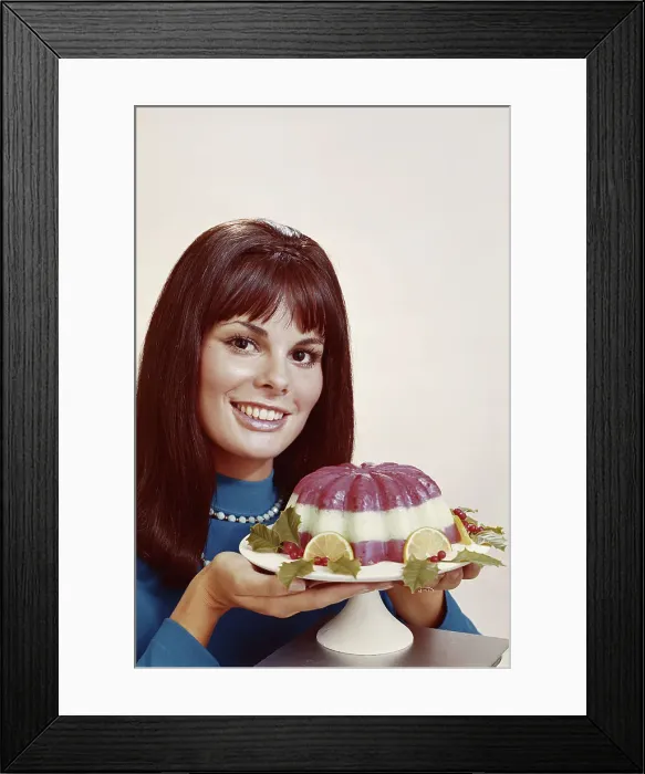 Framed Print : Woman holding mousse against white background, close-up, portrait