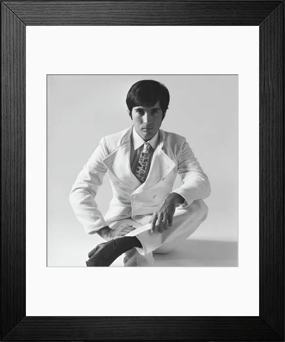 Framed Print : Young man sitting on white background, portrait