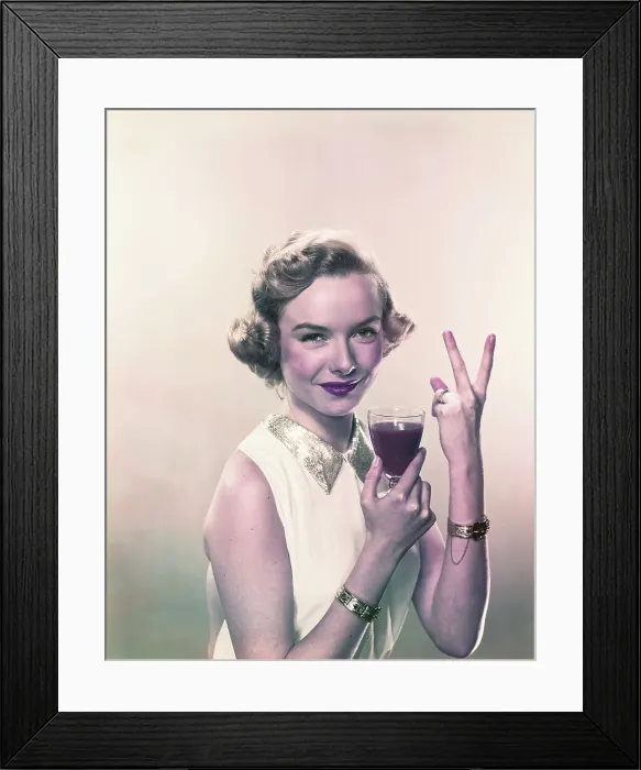 Framed Print : Young woman showing v sign with wine glass, smiling, portrait Framed Print : Young woman showing v sign with wine glass, smiling, portrait