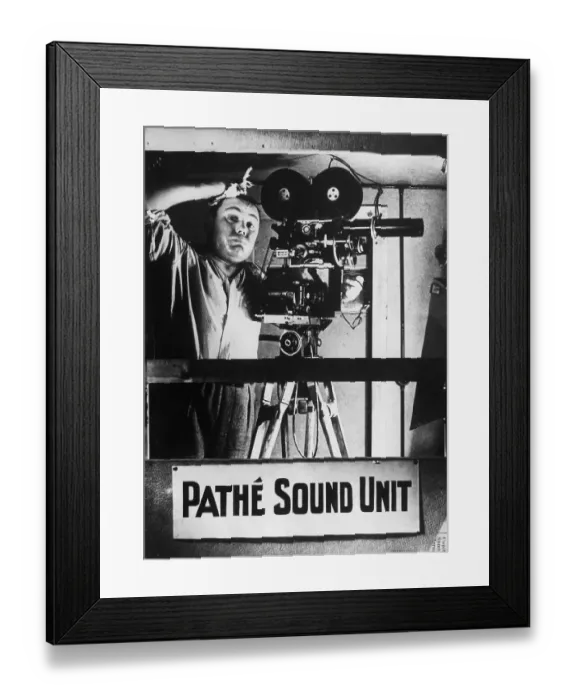 Framed Print : Phew !. circa 1930: A camera operator in a Pathe News studio in London is suffering Framed Print : Phew !. circa 1930: A camera operator in a Pathe News studio in London is suffering