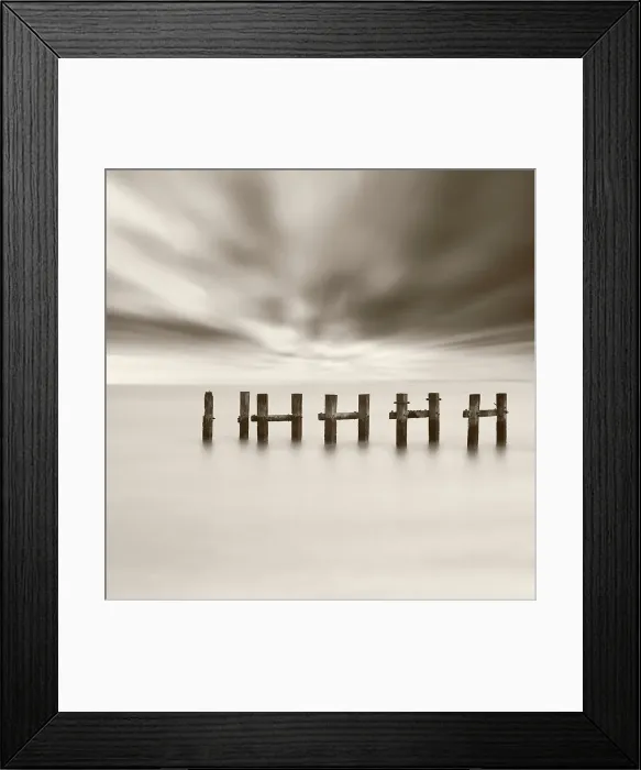 Framed Print : Old jetty posts in sea