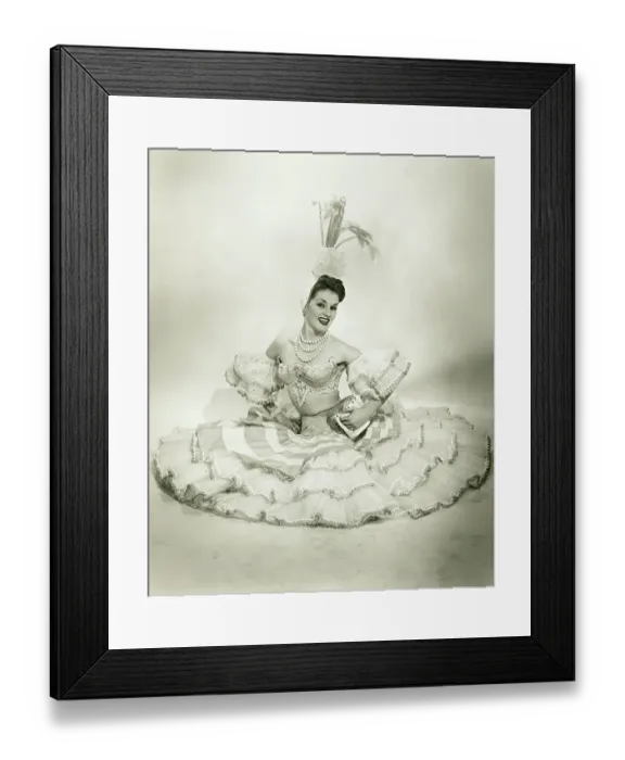 Framed Print : Woman in Latino dance costume sitting in studio, holding drum, (B&W) Framed Print : Woman in Latino dance costume sitting in studio, holding drum, (B&W)