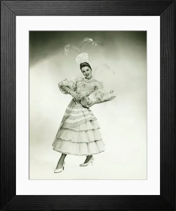 Framed Print : Woman in Latino dance costume posing in studio, holding drum, (B&W) Framed Print : Woman in Latino dance costume posing in studio, holding drum, (B&W)
