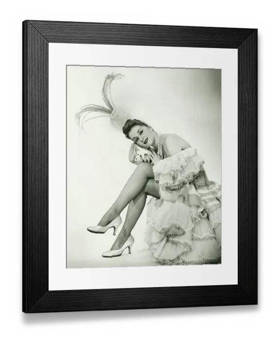 Framed Print : Woman in Latino dance costume sitting in studio, holding drum, (B&W)