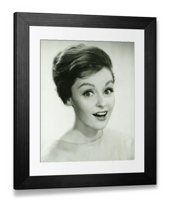 Framed Print : Young woman smiling, posing in studio, (B&W), (Portrait)
