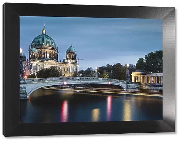 Berlin Cathedral on the Spree River with passing excursion steamer, light traces, dusk, Berlin, Germany