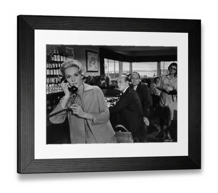 Framed Print : The Birds. American actress Tippi Hedren makes a telephone call in a scene Framed Print : The Birds. American actress Tippi Hedren makes a telephone call in a scene