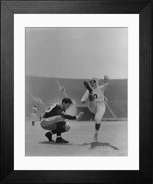 Framed Print : High Kick. 1938: Joan Davis doing a high-kick on the football field, in a scene Framed Print : High Kick. 1938: Joan Davis doing a high-kick on the football field, in a scene