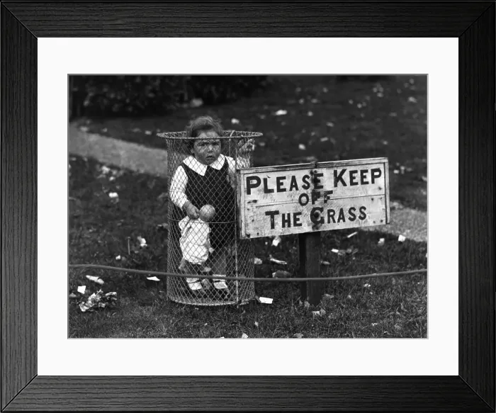 Framed Print : Creche. 1st October 1928: A child standing in a park rubbish bin Framed Print : Creche. 1st October 1928: A child standing in a park rubbish bin