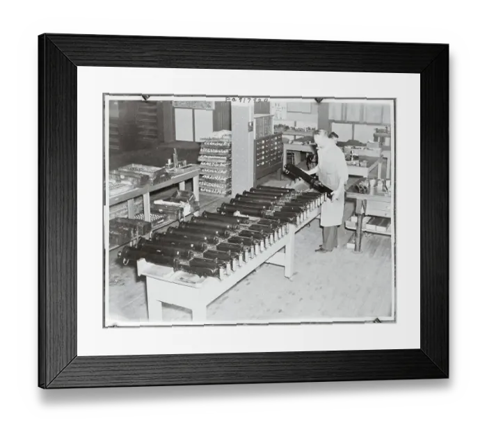 Framed Print : Man Inspecting Machine Guns