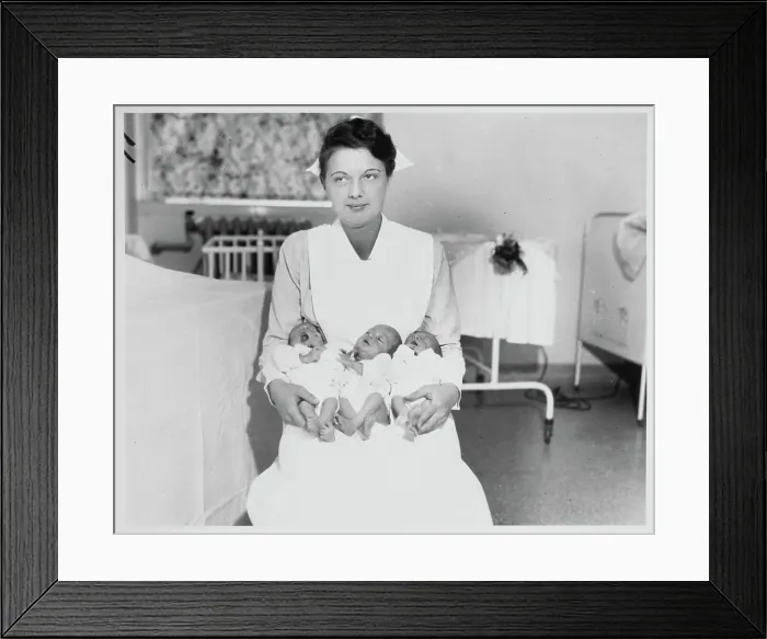 Framed Print : Nurse Holding Triplets Framed Print : Nurse Holding Triplets