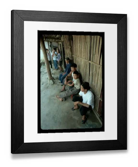 Framed Print : Family Seated Against Bamboo Wall Framed Print : Family Seated Against Bamboo Wall