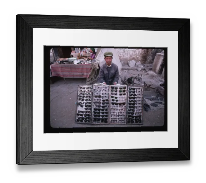 Framed Print : Tibetan Merchant Selling Sunglasses Framed Print : Tibetan Merchant Selling Sunglasses