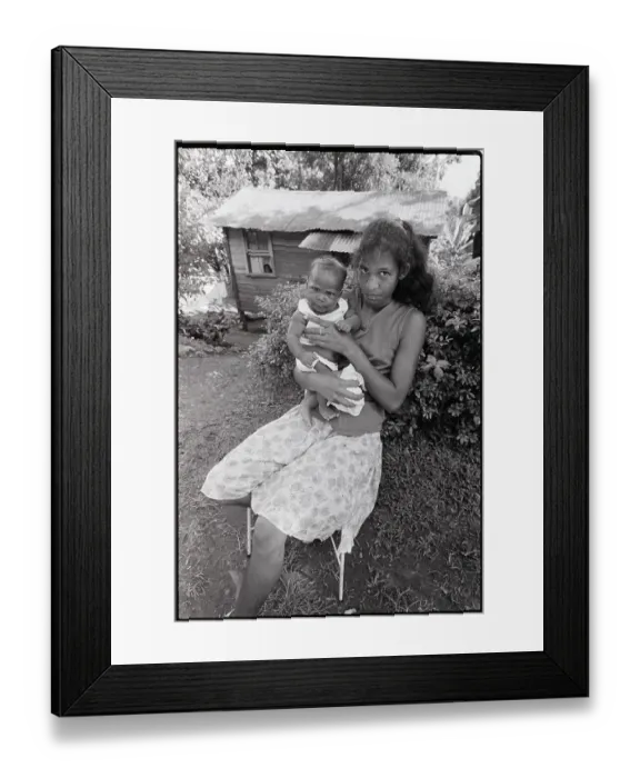 Framed Print : Woman Seated with Baby in Front of Home Framed Print : Woman Seated with Baby in Front of Home