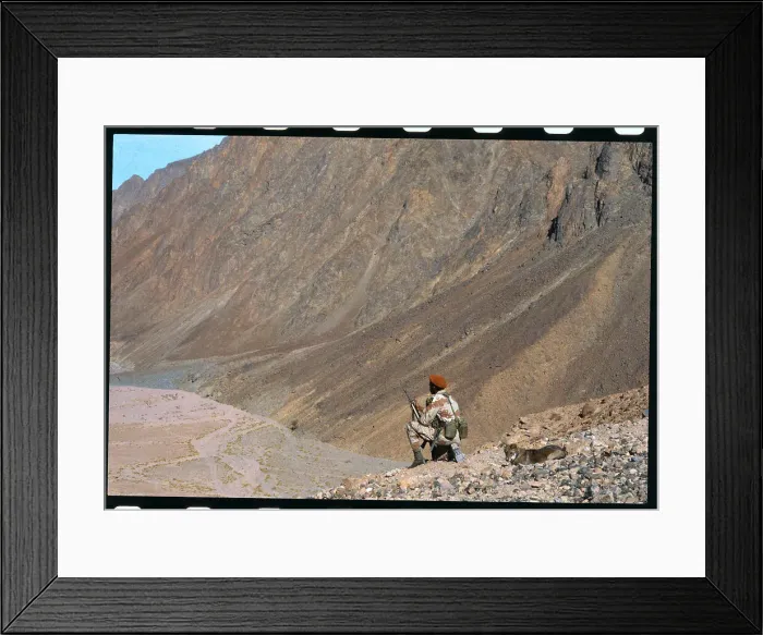 Framed Print : One Man Stooping Down on Hillside