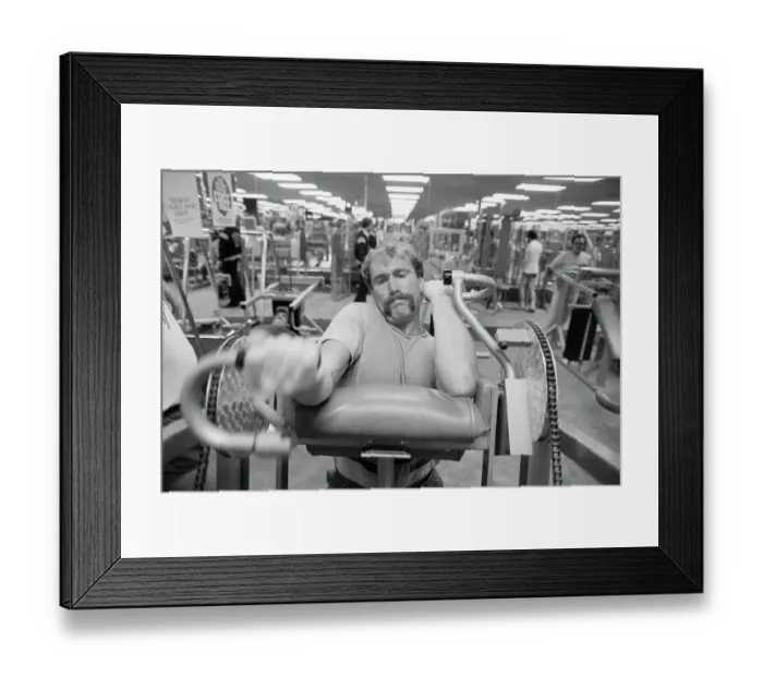 Framed Print : Football Player Working on Exercise Machine