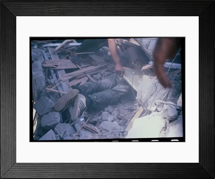 Framed Print : Worker Uncovering Victim of Bomb Blast