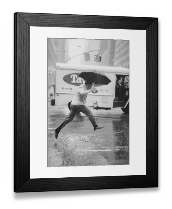 Framed Print : Pedestrian Leaping Over Puddle Framed Print : Pedestrian Leaping Over Puddle
