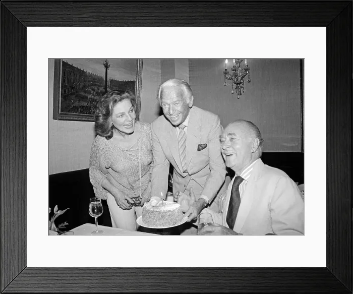 Framed Print : Lauren Bacall Presenting a Cake to Brian Aherne Framed Print : Lauren Bacall Presenting a Cake to Brian Aherne